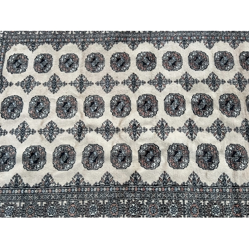 12A - A 20TH CENTURY CREAM GROUND CARPET (PROBABLY BOKHARA).
(200cm x 123cm)