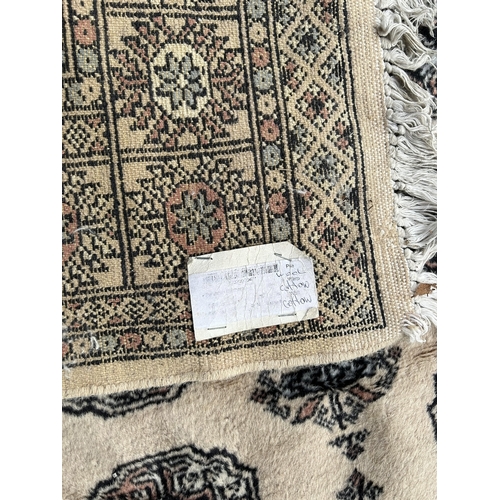 12A - A 20TH CENTURY CREAM GROUND CARPET (PROBABLY BOKHARA).
(200cm x 123cm)