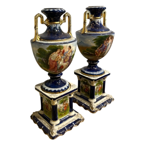 147A - A.G. HARLEY JONES, AN EDWARDIAN PAIR OF HAND PAINTED STONEWARE TWIN HANDLED VASES/URNS
On columned s... 