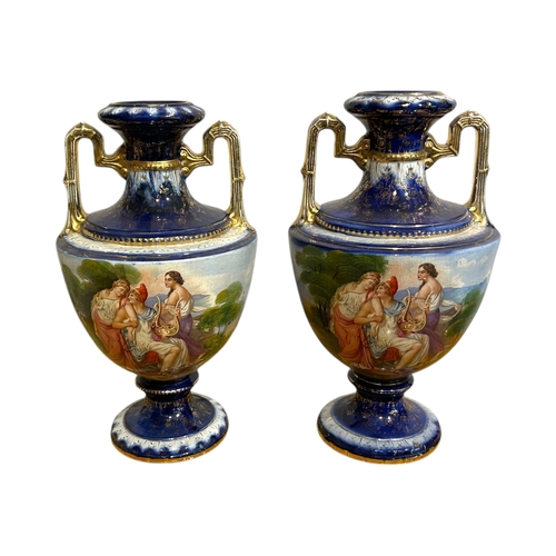 147A - A.G. HARLEY JONES, AN EDWARDIAN PAIR OF HAND PAINTED STONEWARE TWIN HANDLED VASES/URNS
On columned s... 