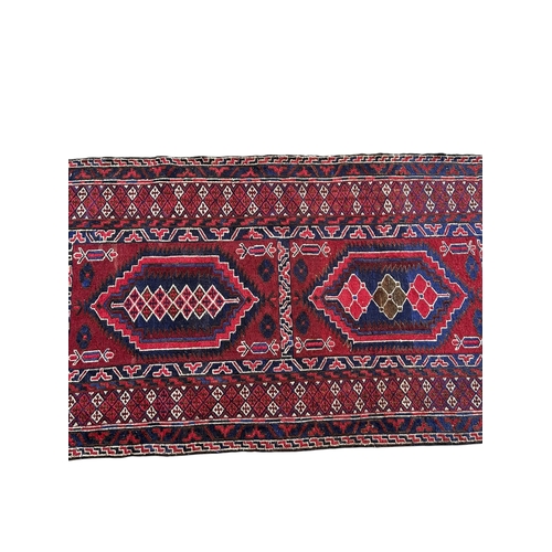 14A - A 20TH CENTURY RED GROUND RUNNER (PROBABLY AFGHAN).
(255cm x 74.5cm)