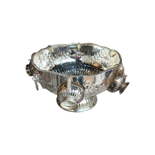 151A - A LARGE 20TH CENTURY SILVER PLATED PUNCH BOWL AND SIX CUPS
Having floral chased and repoussé decorat... 