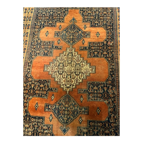 19A - A 20TH CENTURY ORANGE GROUND CARPET (PROBABLY SENNEH).
(186cm x 137cm)