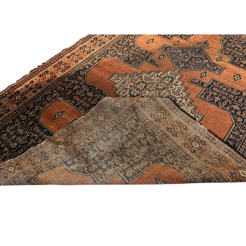 19A - A 20TH CENTURY ORANGE GROUND CARPET (PROBABLY SENNEH).
(186cm x 137cm)