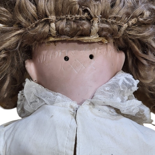 139A - KÄMMER & REINHARDT AND SIMON & HALBIG, A LARGE LATE 19TH CENTURY GERMAN BISQUE DOLL.
(approx 65cm)