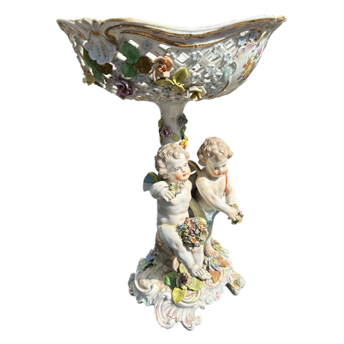 108 - CARL THIEME, A LATE 19TH CENTURY PORCELAIN CENTREPIECE
Decorated with two cherubs with various flora... 