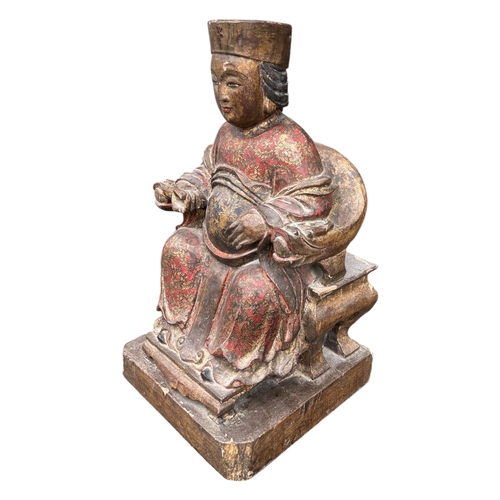 122A - A LARGE CHINESE CARVED WOOD AND POLYCHROME PAINTED FIGURES OF A SEATED EMPEROR ON THRONE
Traces of g... 