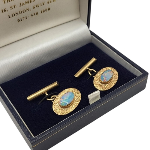 102 - A 9CT GOLD AND OPAL CUFFLINKS
Oval forms with bezel set flat oval cabochon cut opals (approx. 10mm x... 