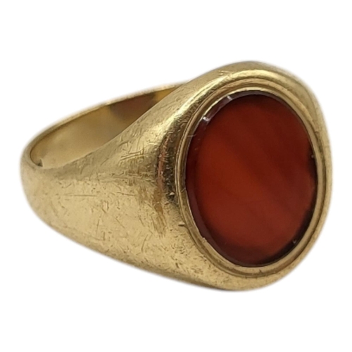 106 - A 9CT GOLD AND CARNELIAN GENTLEMAN’S SIGNET RING, CIRCA 1970
Having central flat oval cut carnelian ... 