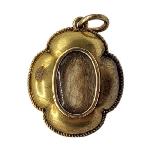 142 - A 19TH CENTURY VICTORIAN YELLOW METAL AND GARNET ESTRUSCIAN REVIVAL MOURNING PENDANT (YELLOW METAL T... 