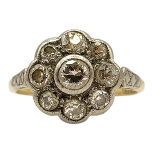 4 - AN EDWARDIAN 18CT GOLD AND PLATINUM DIAMOND CLUSTER RING
Having central round brilliant cut diamond ... 