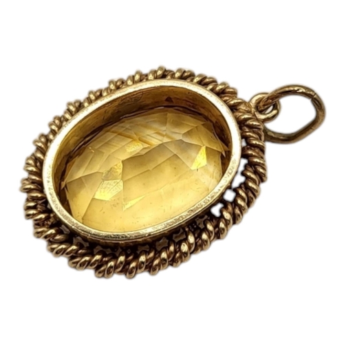 48 - A LARGE 20TH CENTURY YELLOW METAL AND CITRINE PENDANT (YELLOW METAL TESTED AS 9CT GOLD)
Oval form ha... 