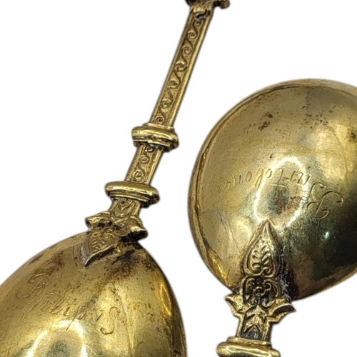 61 - A PAIR OF LATE 19TH CENTURY DUTCH SILVER GILT APOSTLE ANOINTING SPOONS, HAVING ST. BARTHOLOMEW & ST.... 