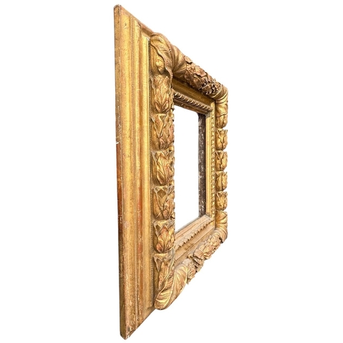 572 - A LATE 16TH/EARLY 17TH CENTURY ITALIAN CARVED WALNUT GILTWOOD FRAMED MIRROR
Decorated with acanthus ... 