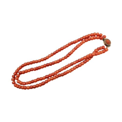 63 - A 19TH CENTURY TWO-STRAND CORAL BEAD NECKLACE WITH YELLOW METAL AND CORAL CLASP (YELLOW METAL TESTED... 