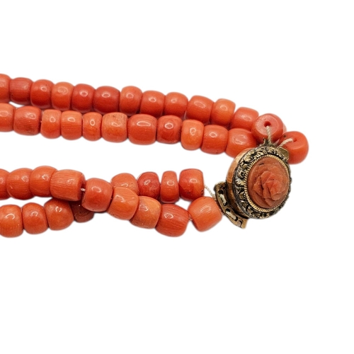 63 - A 19TH CENTURY TWO-STRAND CORAL BEAD NECKLACE WITH YELLOW METAL AND CORAL CLASP (YELLOW METAL TESTED... 