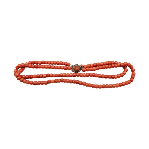 63 - A 19TH CENTURY TWO-STRAND CORAL BEAD NECKLACE WITH YELLOW METAL AND CORAL CLASP (YELLOW METAL TESTED... 