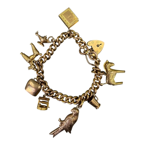 505 - 20TH CENTURY 9CT GOLD CURB LINK CHARM BRACELET WITH ATTACHED 9CT GOLD CHARMS
Heart lock clasp with m... 