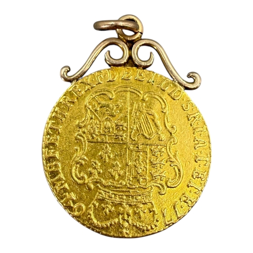 507 - AN 18TH CENTURY GEORGE III GOLD HALF GUINEA COIN, DATED 1764
Mounted on a 9ct gold pendant mount. 
(... 