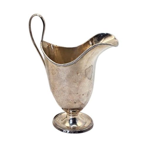 512 - JOHN YOUNGE & CO., AN 18TH CENTURY GEORGE III SILVER MILK JUG
Hallmarked Sheffield, 1780, helmet for... 