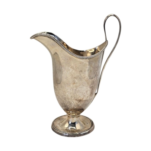 512 - JOHN YOUNGE & CO., AN 18TH CENTURY GEORGE III SILVER MILK JUG
Hallmarked Sheffield, 1780, helmet for... 