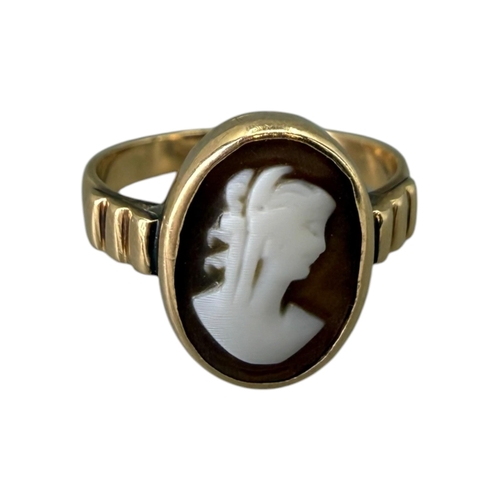 521 - A LATE VICTORIAN 12CT GOLD AND CARVED SHELL CAMEO RING
Oval form, carved shell cameo depicting a bus... 