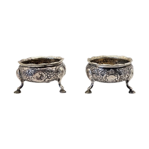 522 - A PAIR OF 18TH CENTURY GEORGE II SILVER SALTS
Hallmarked London, having repoussé chased floral and l... 
