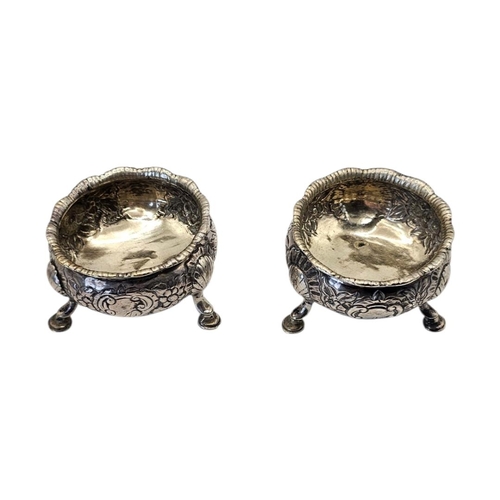 522 - A PAIR OF 18TH CENTURY GEORGE II SILVER SALTS
Hallmarked London, having repoussé chased floral and l... 