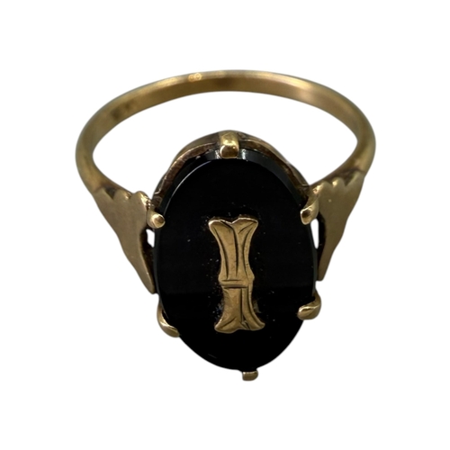 525 - A 20TH CENTURY 9CT GOLD AND ONYX RING
Having central flat carved oval onyx (approx.12.5mm x 8mm) wit... 