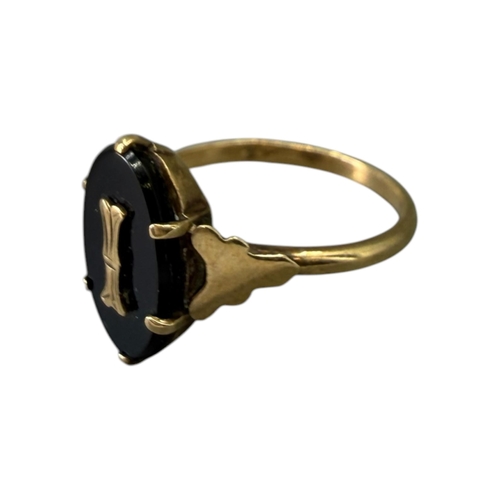 525 - A 20TH CENTURY 9CT GOLD AND ONYX RING
Having central flat carved oval onyx (approx.12.5mm x 8mm) wit... 