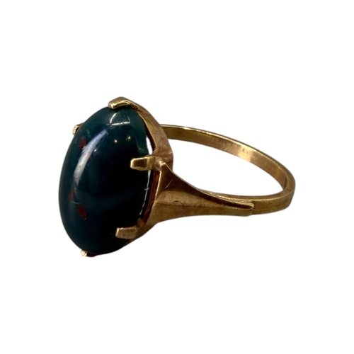 533 - A 20TH CENTURY 9CT GOLD AND BLOODSTONE CABOCHON CUT RING
The central oval cabochon cut bloodstone (a... 