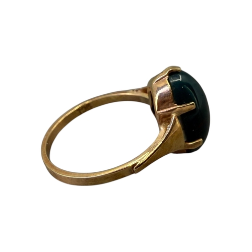 533 - A 20TH CENTURY 9CT GOLD AND BLOODSTONE CABOCHON CUT RING
The central oval cabochon cut bloodstone (a... 