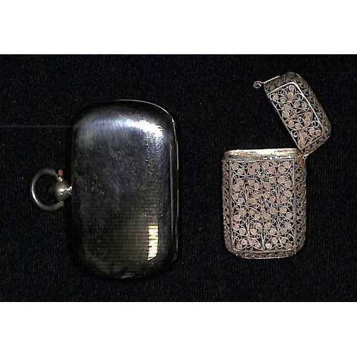 828 - Silver. A fine filigree silver flower patterned case, opening lid at the top, 46x28x9mm; and a horiz... 