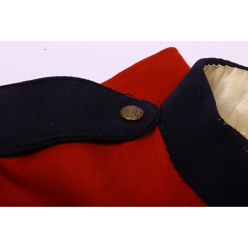 106 - Victorian scarlet wool tunic with blue cloth collar, epaulettes and facing. Bearing gold lace rank c... 