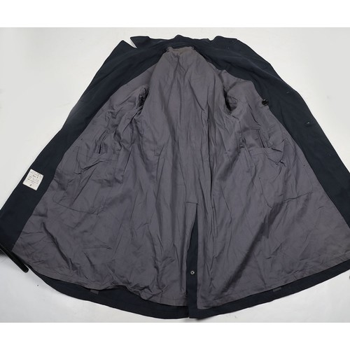 900 - RAF Officer's Peaked Cap & Rain Coat. Cold War. A fair condition example of a RAF Officers peake... 