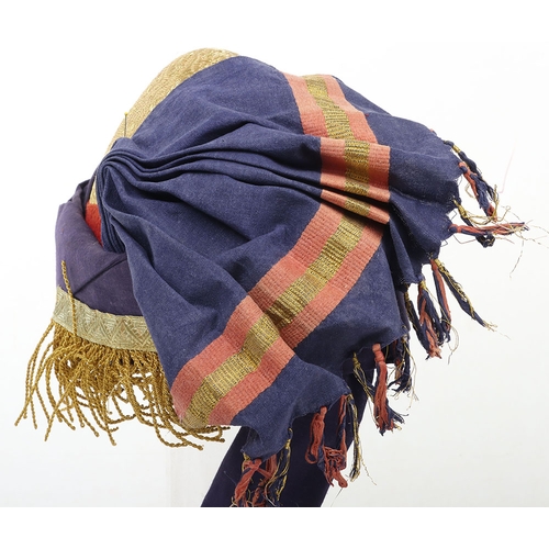 52 - Indian Turban, of recent manufacture, made from blue cloth with gilt embroidery and badge ( glued to... 