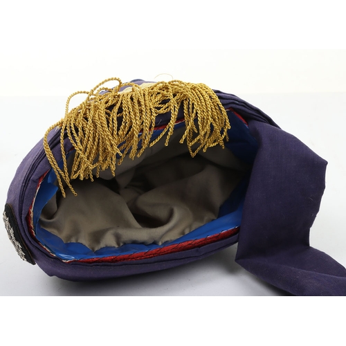 52 - Indian Turban, of recent manufacture, made from blue cloth with gilt embroidery and badge ( glued to... 
