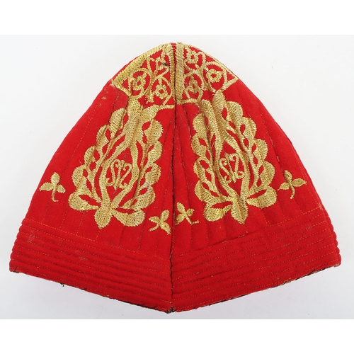 55 - Indian Army Kulla, made from scarlet cloth with gilt embroidery, fawn lining and brown headband stam... 