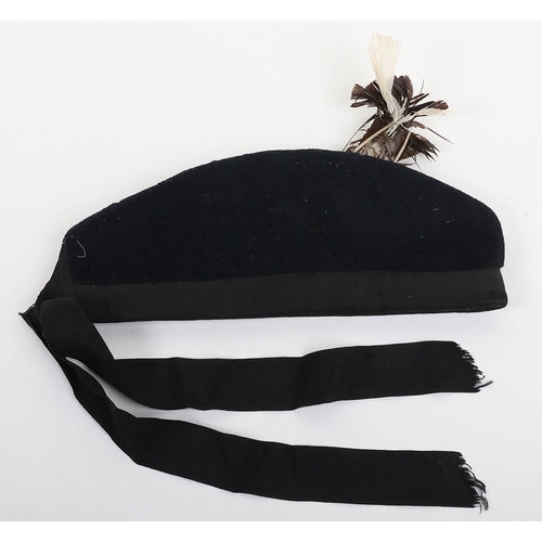 37 - Scottish Glengarry, blue wool with ribboned lower band, two tallies to the rear. Feather hackle behi... 