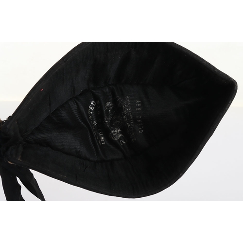 37 - Scottish Glengarry, blue wool with ribboned lower band, two tallies to the rear. Feather hackle behi... 