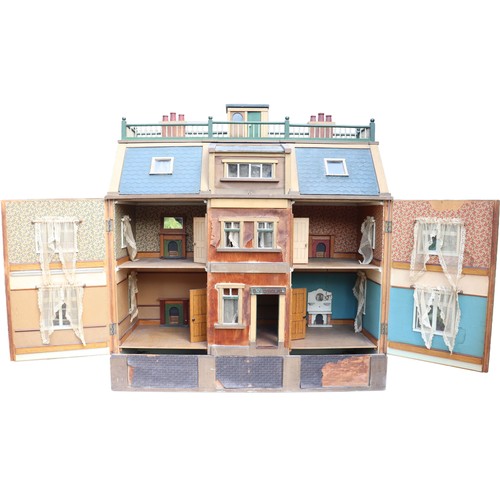 3 - ‘DollyHolme’ an early 20th century well-made wooden dolls house and contents, the painted wooden dol... 