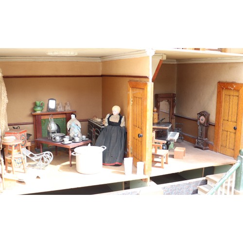 3 - ‘DollyHolme’ an early 20th century well-made wooden dolls house and contents, the painted wooden dol... 