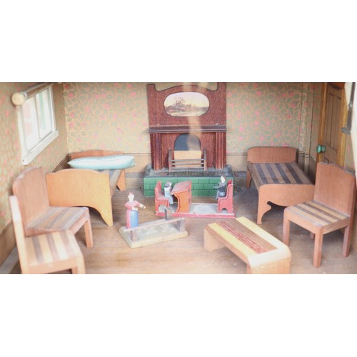 3 - ‘DollyHolme’ an early 20th century well-made wooden dolls house and contents, the painted wooden dol... 