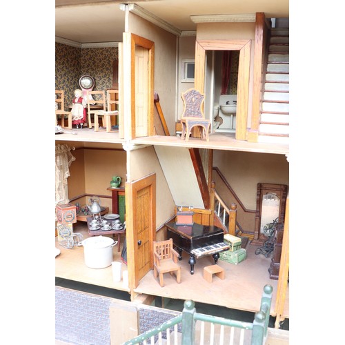 3 - ‘DollyHolme’ an early 20th century well-made wooden dolls house and contents, the painted wooden dol... 