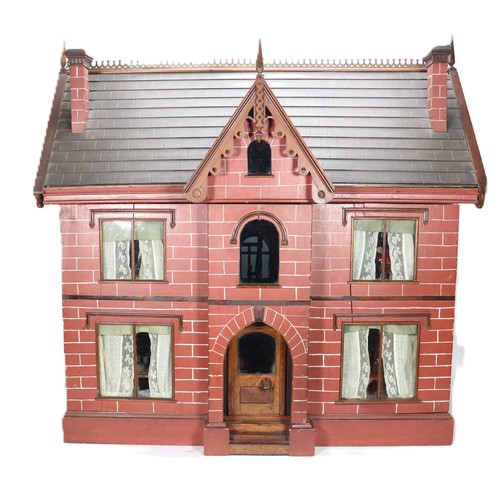 2 - A good painted red brick wooden Victorian Dolls house in the Gothic style, with contents, the façade... 