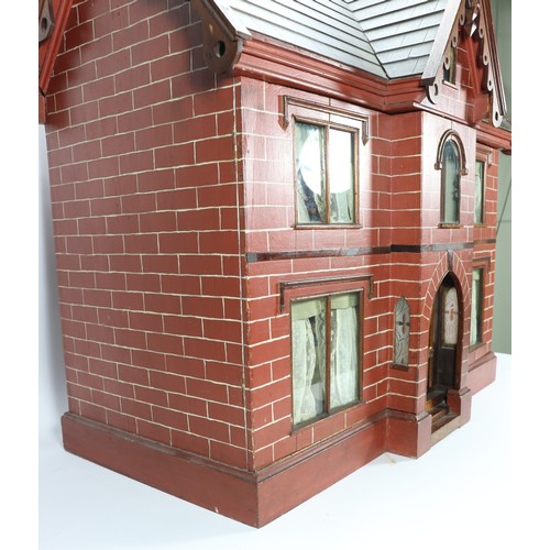 2 - A good painted red brick wooden Victorian Dolls house in the Gothic style, with contents, the façade... 