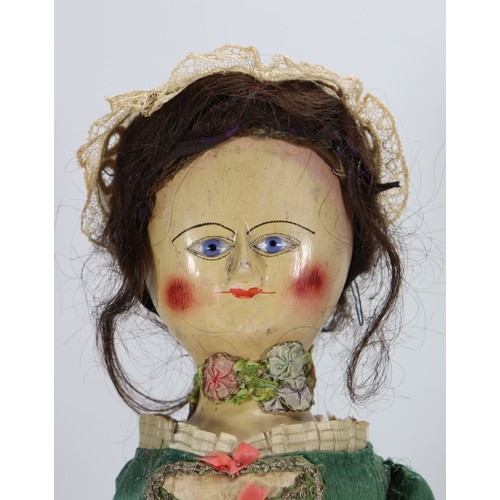 45 - A good early English George II painted wooden doll, circa 1750, the gesso head with inset blue glass... 