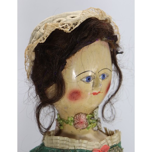 45 - A good early English George II painted wooden doll, circa 1750, the gesso head with inset blue glass... 