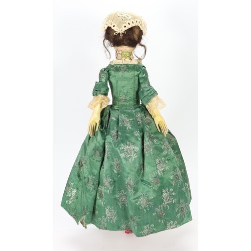 45 - A good early English George II painted wooden doll, circa 1750, the gesso head with inset blue glass... 