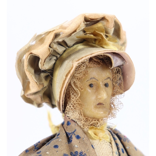48 - An early nineteenth century English wax peddler doll, the bees wax head with black beaded eyes, pain... 